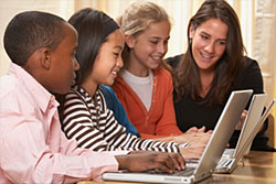 Image of teacher working with students